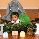small baby in green tutu laying with stuffed animals and INBY block letters