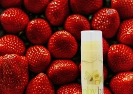 inbybaby lip balm on top of vivid red strawberries