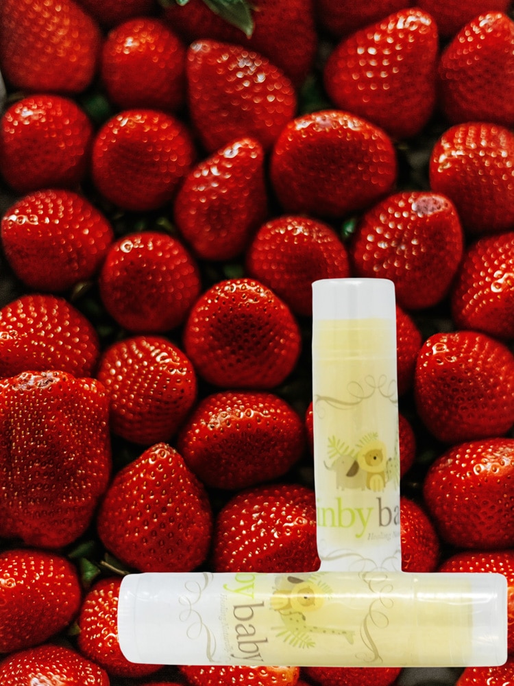 inbybaby lip balm on top of vivid red strawberries