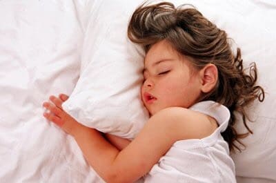 Little girl sleeping on pillow